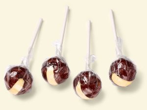 Küfa choco lolly with vanilla flavour, brown ball-shaped lollies with yellow stripe